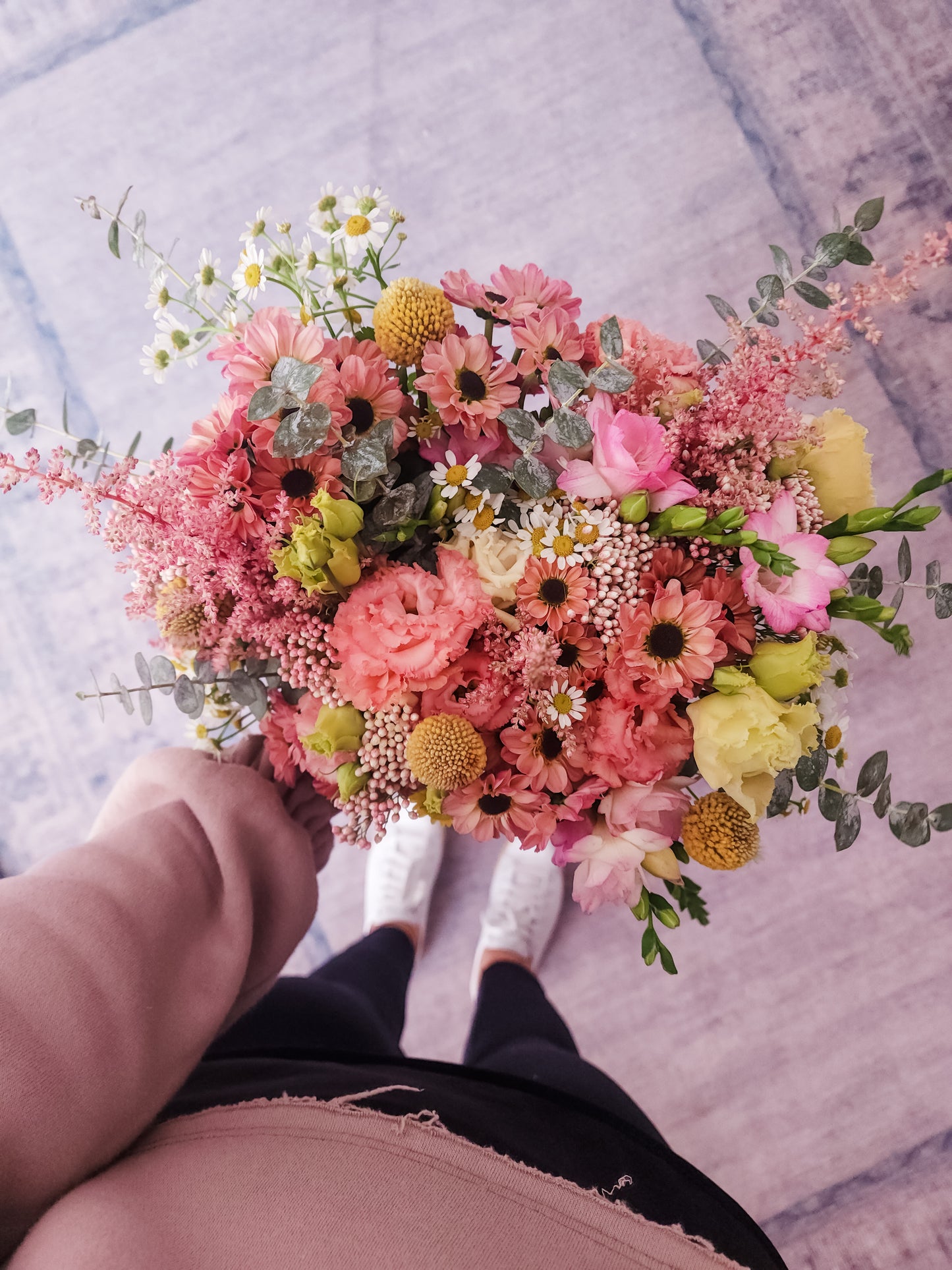 A bouquet of pink and yellow flowers